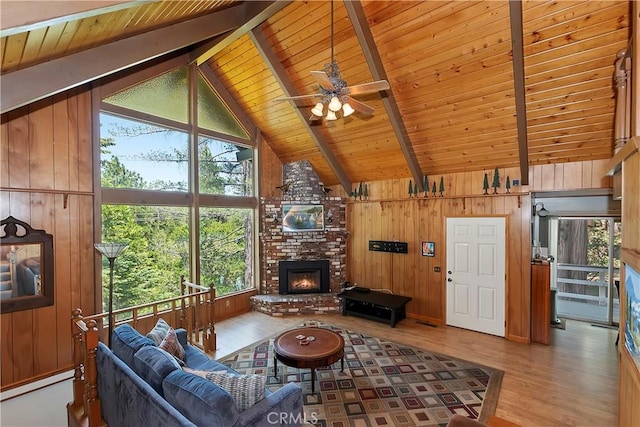 535 Pioneer Rd, Lake Arrowhead, CA 92352 - living area featuring wooden ceiling, wood walls, wood finished floors, plenty of natural light, and a brick fireplace