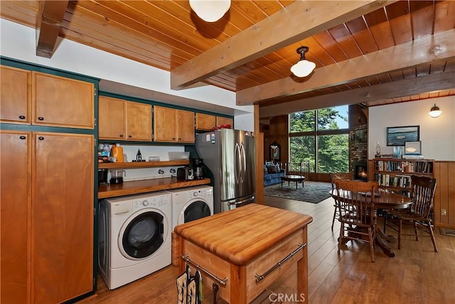 535 Pioneer Rd, Lake Arrowhead, CA 92352 - kitchen with freestanding refrigerator, washing machine and clothes dryer, a wood ceiling with exposed beams, wood finished floors, and brown cabinetry