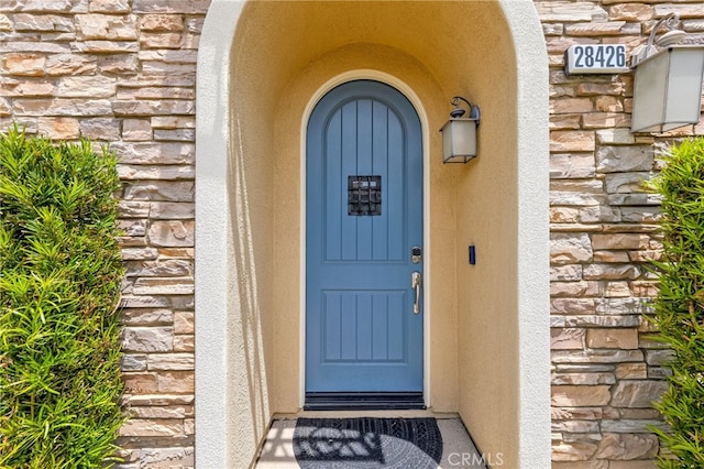 28426 Herrera St, Valencia, CA 91354 - doorway to property featuring stone siding