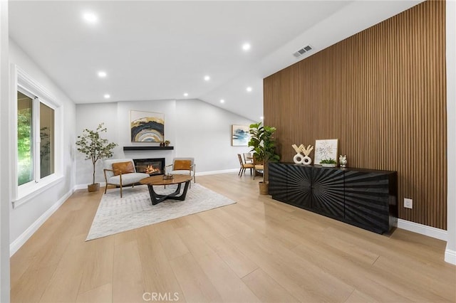 8093 Banyan St, Rancho Cucamonga, CA 91701 - living room with a glass covered fireplace, light wood-type flooring, recessed lighting, lofted ceiling, and baseboards