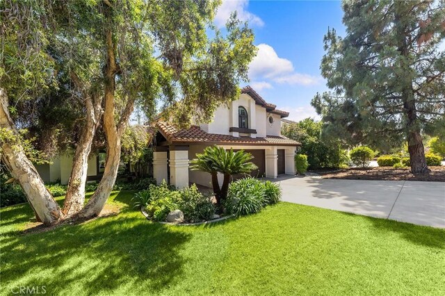 8093 Banyan St, Rancho Cucamonga, CA 91701 - view of front facade featuring a tile roof, stucco siding, concrete driveway, an attached garage, and a front lawn