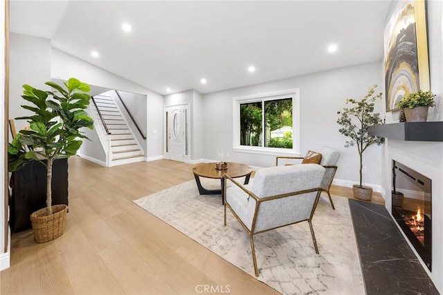 8093 Banyan St, Rancho Cucamonga, CA 91701 - living room with stairway, a glass covered fireplace, wood finished floors, recessed lighting, and baseboards