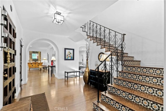 3101 San Gabriel Ave, Glendale, CA 91208 - stairs featuring arched walkways, wood finished floors, and baseboards