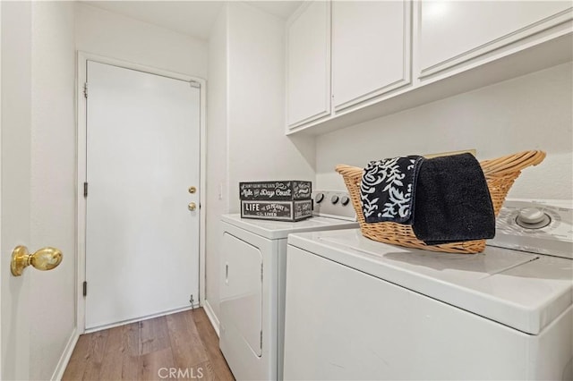 27523 Wellington Ct, Valencia, CA 91354 - laundry room featuring washing machine and clothes dryer, light wood-style floors, cabinet space, and baseboards