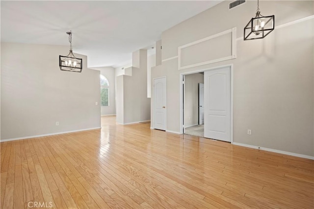 27523 Wellington Ct, Valencia, CA 91354 - empty room with a chandelier, light wood-style floors, and baseboards