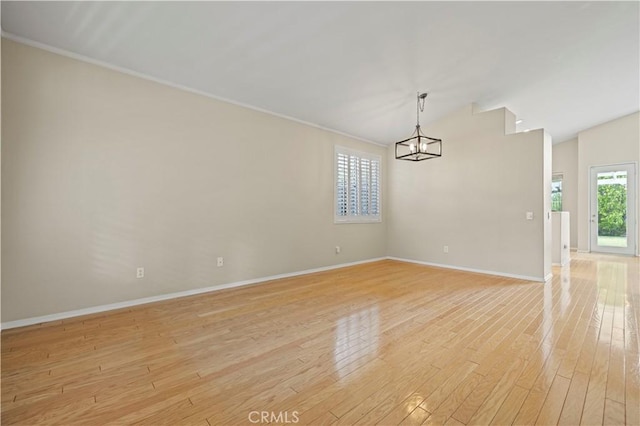 27523 Wellington Ct, Valencia, CA 91354 - unfurnished room featuring light wood finished floors, baseboards, a chandelier, crown molding, and vaulted ceiling