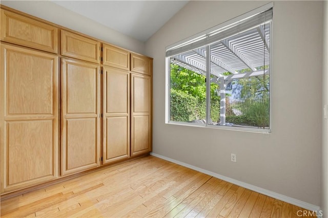 27523 Wellington Ct, Valencia, CA 91354 - unfurnished bedroom with baseboards, light wood finished floors, and lofted ceiling