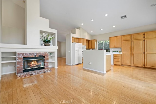 27523 Wellington Ct, Valencia, CA 91354 - kitchen featuring white appliances, lofted ceiling, open floor plan, light wood finished floors, and light countertops