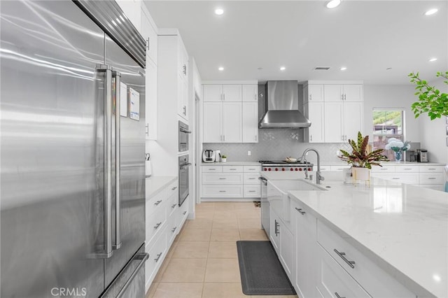 100 Bright Star, Irvine, CA 92618 - kitchen featuring appliances with stainless steel finishes, wall chimney range hood, light tile patterned floors, a sink, and recessed lighting