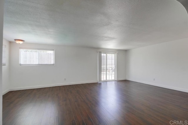 1695 Bubbling Well Dr, San Diego, CA 92154 - empty room featuring a textured ceiling, dark wood-style floors, and baseboards