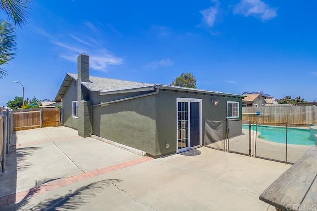 1695 Bubbling Well Dr, San Diego, CA 92154 - back of house featuring stucco siding, a patio area, a fenced backyard, and a chimney