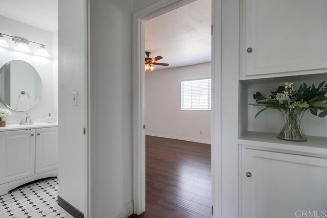 1695 Bubbling Well Dr, San Diego, CA 92154 - bathroom with baseboards, vanity, ceiling fan, and wood finished floors