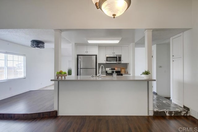 1695 Bubbling Well Dr, San Diego, CA 92154 - kitchen featuring stainless steel appliances, a sink, baseboards, and dark wood-style floors