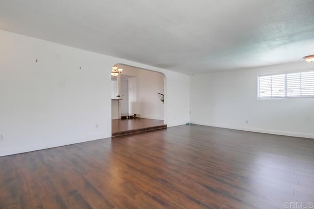 1695 Bubbling Well Dr, San Diego, CA 92154 - spare room with wood finished floors, arched walkways, a chandelier, and baseboards