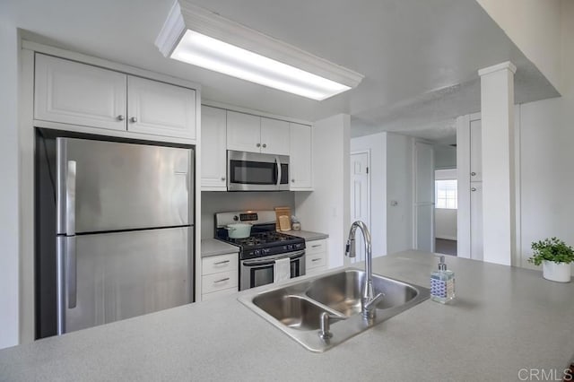 1695 Bubbling Well Dr, San Diego, CA 92154 - kitchen featuring stainless steel appliances, a sink, white cabinets, and light countertops