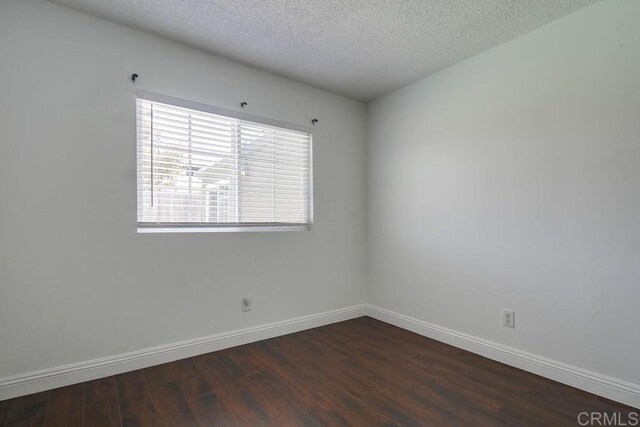 1695 Bubbling Well Dr, San Diego, CA 92154 - empty room featuring dark wood-style floors, baseboards, and a textured ceiling