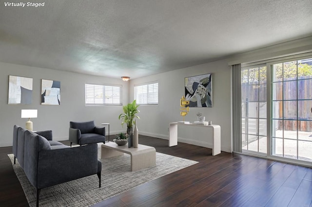 1695 Bubbling Well Dr, San Diego, CA 92154 - living room featuring a textured ceiling, dark wood-style flooring, and baseboards