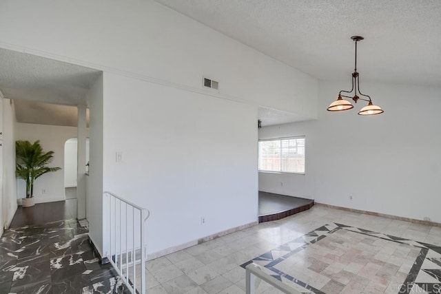 1695 Bubbling Well Dr, San Diego, CA 92154 - empty room with arched walkways, a textured ceiling, and baseboards