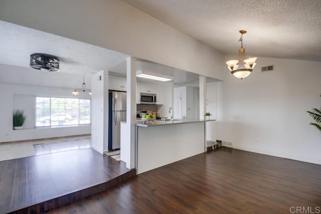 1695 Bubbling Well Dr, San Diego, CA 92154 - kitchen featuring appliances with stainless steel finishes, a chandelier, a textured ceiling, dark wood-type flooring, and open floor plan