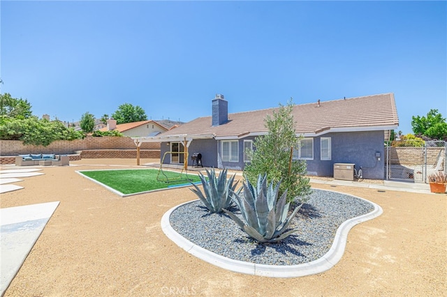 41438 Almond Ave, Palmdale, CA 93551 - rear view of house featuring a patio, stucco siding, an outdoor living space, and a chimney
