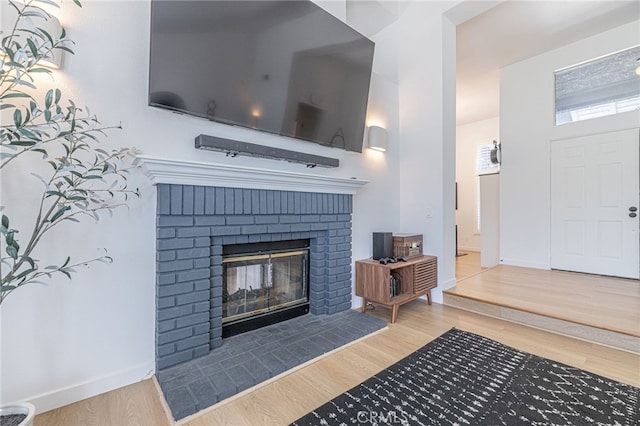 41438 Almond Ave, Palmdale, CA 93551 - detailed view of wood finished floors, a brick fireplace, and baseboards