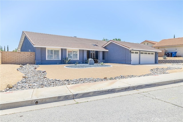 41438 Almond Ave, Palmdale, CA 93551 - ranch-style home featuring a garage, driveway, a tile roof, and stucco siding