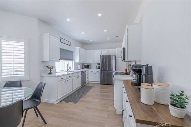 41438 Almond Ave, Palmdale, CA 93551 - kitchen with stainless steel appliances, white cabinets, wood counters, light wood-style floors, and recessed lighting