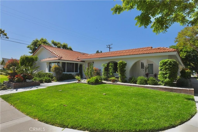 2821 Tucker Ln, Rossmoor, CA 90720 - mediterranean / spanish house featuring stucco siding, a front lawn, and a tiled roof