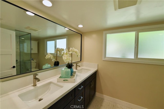 2821 Tucker Ln, Rossmoor, CA 90720 - full bath featuring toilet, double vanity, baseboards, a shower stall, and recessed lighting