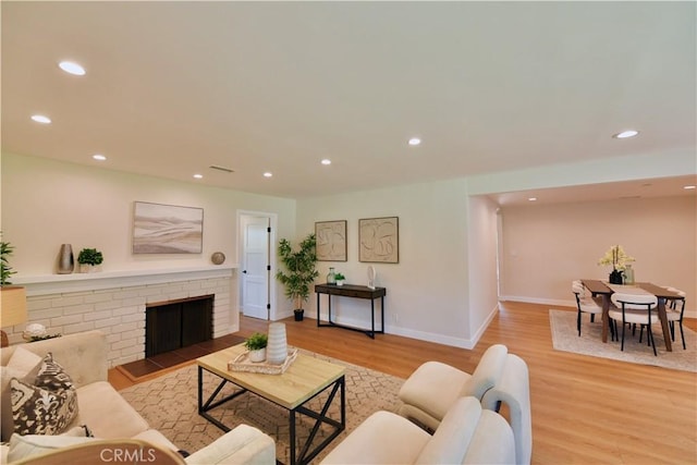2821 Tucker Ln, Rossmoor, CA 90720 - living room with light wood-style flooring, recessed lighting, baseboards, and a brick fireplace