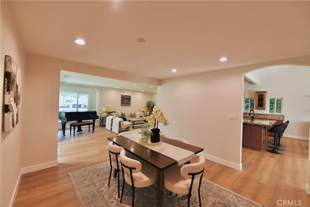 2821 Tucker Ln, Rossmoor, CA 90720 - dining room with arched walkways, light wood-style flooring, plenty of natural light, recessed lighting, and baseboards
