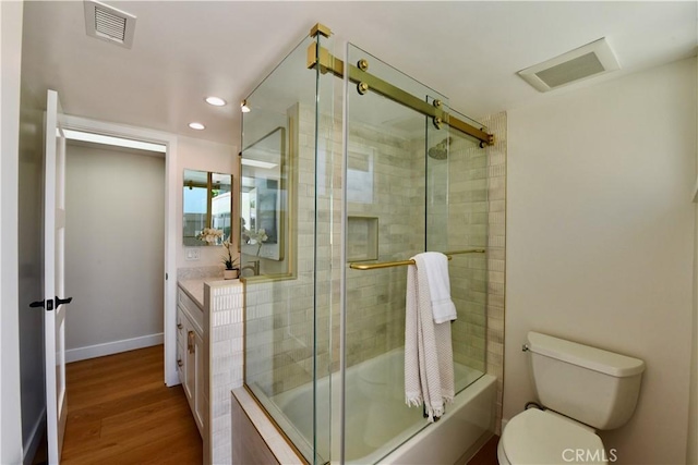 2821 Tucker Ln, Rossmoor, CA 90720 - bathroom with bath / shower combo with glass door, wood finished floors, toilet, recessed lighting, and vanity