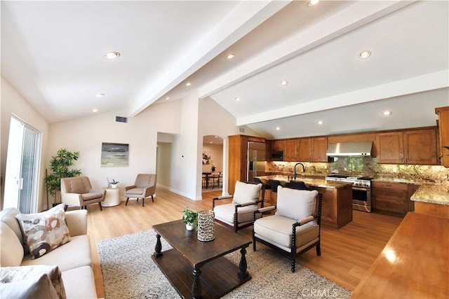 2821 Tucker Ln, Rossmoor, CA 90720 - living room featuring arched walkways, light wood-style floors, recessed lighting, and baseboards