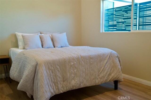 6702 E El Progreso St, Long Beach, CA 90815 - bedroom featuring baseboards and wood finished floors