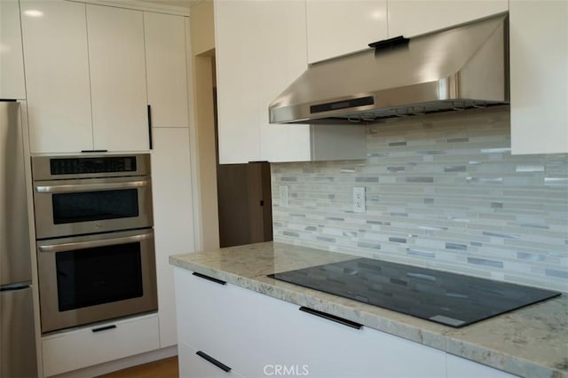6702 E El Progreso St, Long Beach, CA 90815 - kitchen featuring exhaust hood, appliances with stainless steel finishes, backsplash, light stone countertops, and white cabinetry