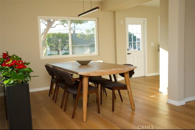 6702 E El Progreso St, Long Beach, CA 90815 - dining room featuring light wood-type flooring, healthy amount of natural light, and baseboards