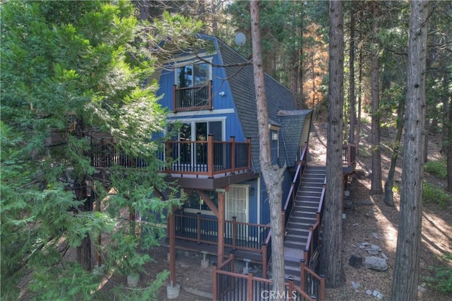 24091 Lakeview Dr, Crestline, CA 92325 - back of property featuring a balcony, stairs, roof with shingles, and a wooden deck