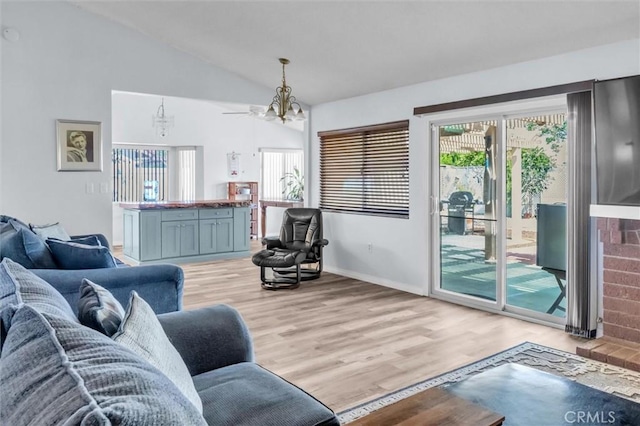 26834 Pinckney Way, Menifee, CA 92586 - living area featuring lofted ceiling, light wood-style flooring, a chandelier, and baseboards