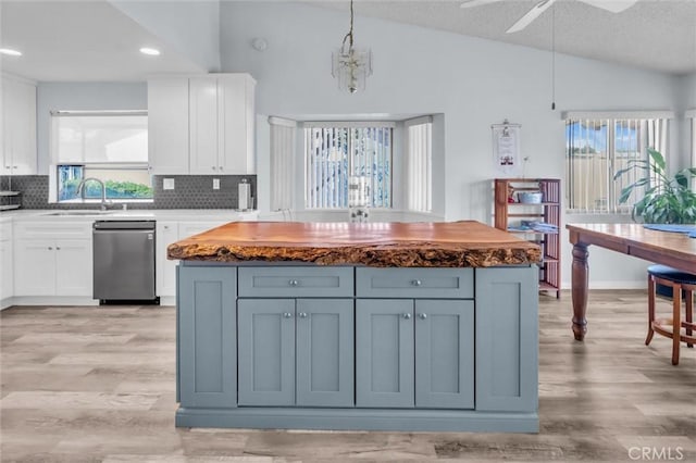 26834 Pinckney Way, Menifee, CA 92586 - kitchen featuring dishwasher, lofted ceiling, decorative backsplash, white cabinetry, and light wood-type flooring