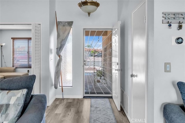 26834 Pinckney Way, Menifee, CA 92586 - foyer featuring wood finished floors, plenty of natural light, and baseboards