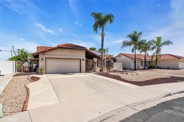 26834 Pinckney Way, Menifee, CA 92586 - mediterranean / spanish-style house with a gate, a tile roof, stucco siding, an attached garage, and concrete driveway