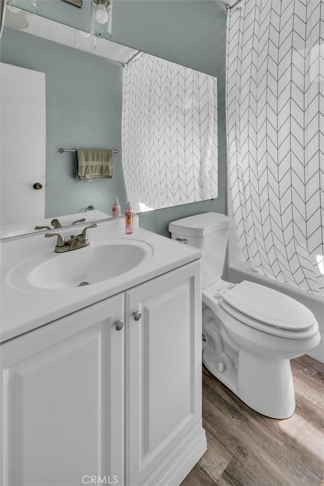 26834 Pinckney Way, Menifee, CA 92586 - bathroom featuring vanity, wood finished floors, toilet, and shower / bath combination with curtain