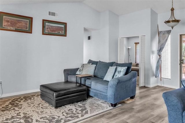 26834 Pinckney Way, Menifee, CA 92586 - living area with lofted ceiling, wood finished floors, and baseboards