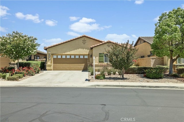 26344 Leos Trl, Menifee, CA 92586 - mediterranean / spanish house featuring an attached garage, stucco siding, driveway, and a tiled roof