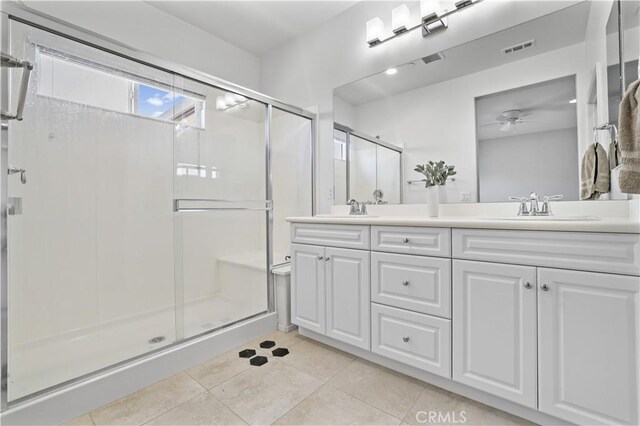 26344 Leos Trl, Menifee, CA 92586 - full bathroom with double vanity, ceiling fan, a stall shower, and tile patterned flooring