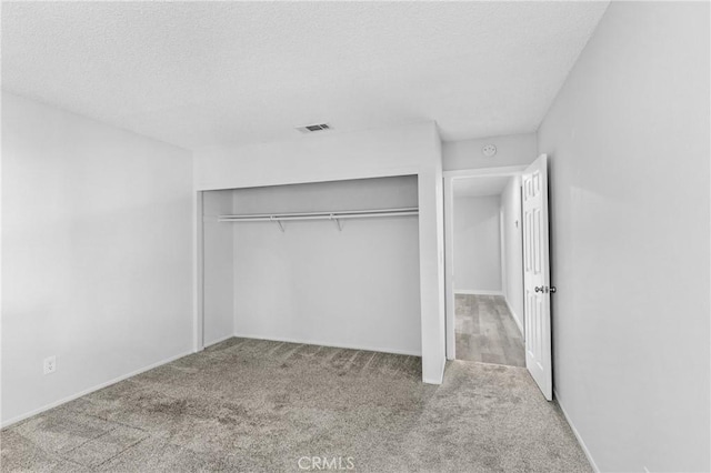 31864 Railroad Canyon Rd Unit 6 D, Canyon Lake, CA 92587 - unfurnished bedroom featuring carpet flooring, a closet, and a textured ceiling