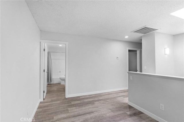 31864 Railroad Canyon Rd Unit 6 D, Canyon Lake, CA 92587 - spare room featuring a textured ceiling, wood finished floors, baseboards, and recessed lighting