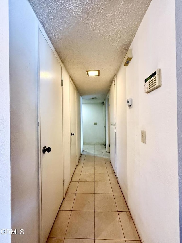 1431 Holly Ave, Oxnard, CA 93036 - hallway with a textured ceiling and light tile patterned flooring