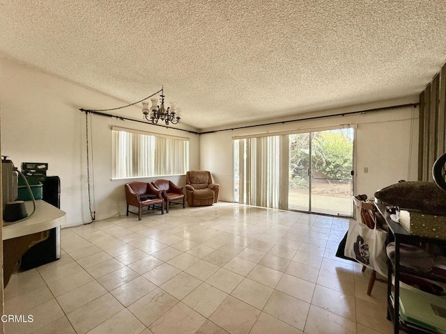 1431 Holly Ave, Oxnard, CA 93036 - living room featuring light tile patterned floors, a chandelier, and a textured ceiling