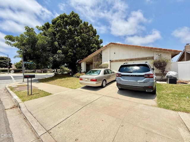 1431 Holly Ave, Oxnard, CA 93036 - view of front of home featuring a garage, concrete driveway, and a front lawn